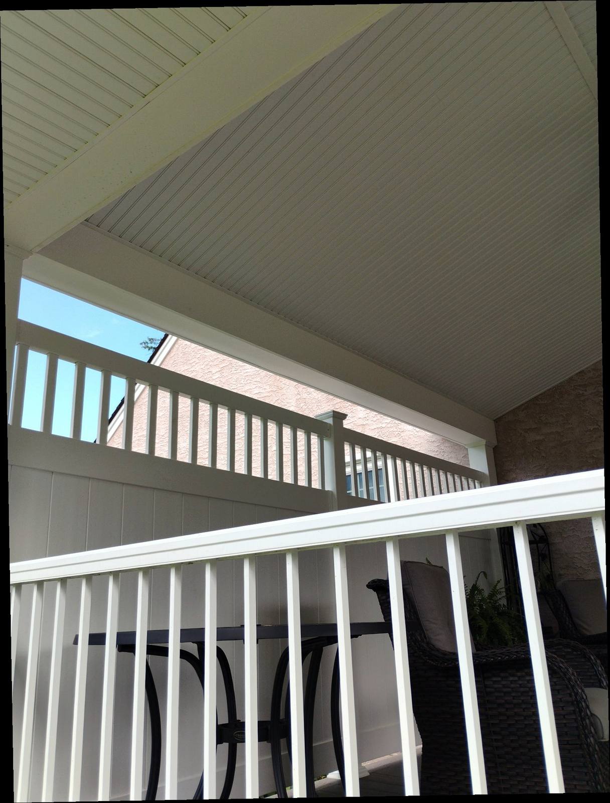White railing and ceiling detail on a covered porch