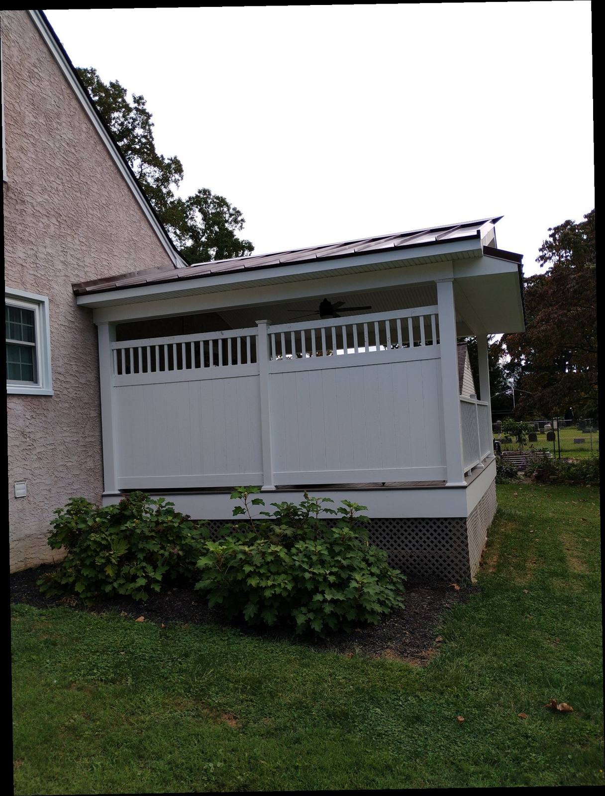 Finished enclosed porch with white privacy panels