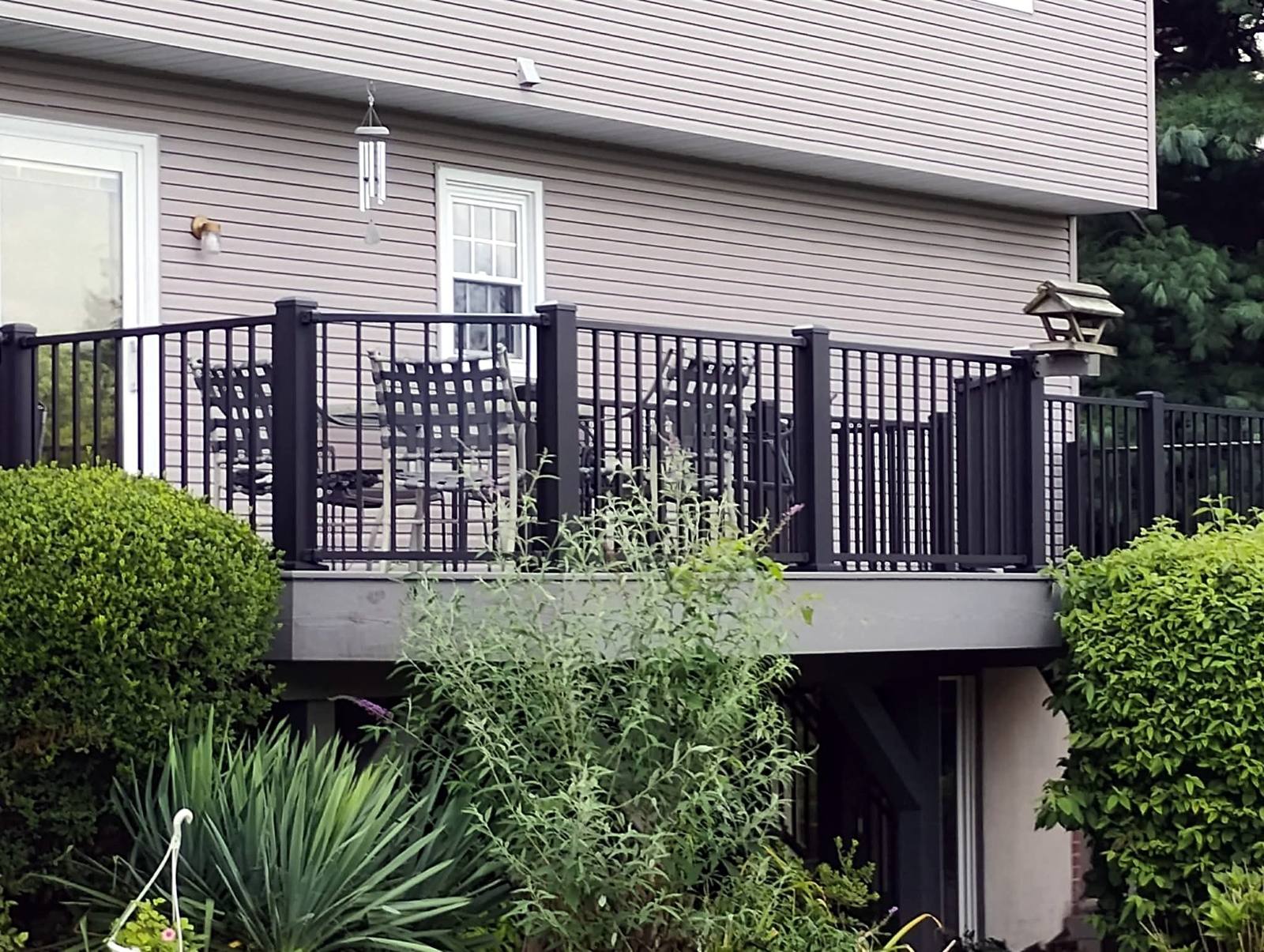Raised gray deck with black metal railing