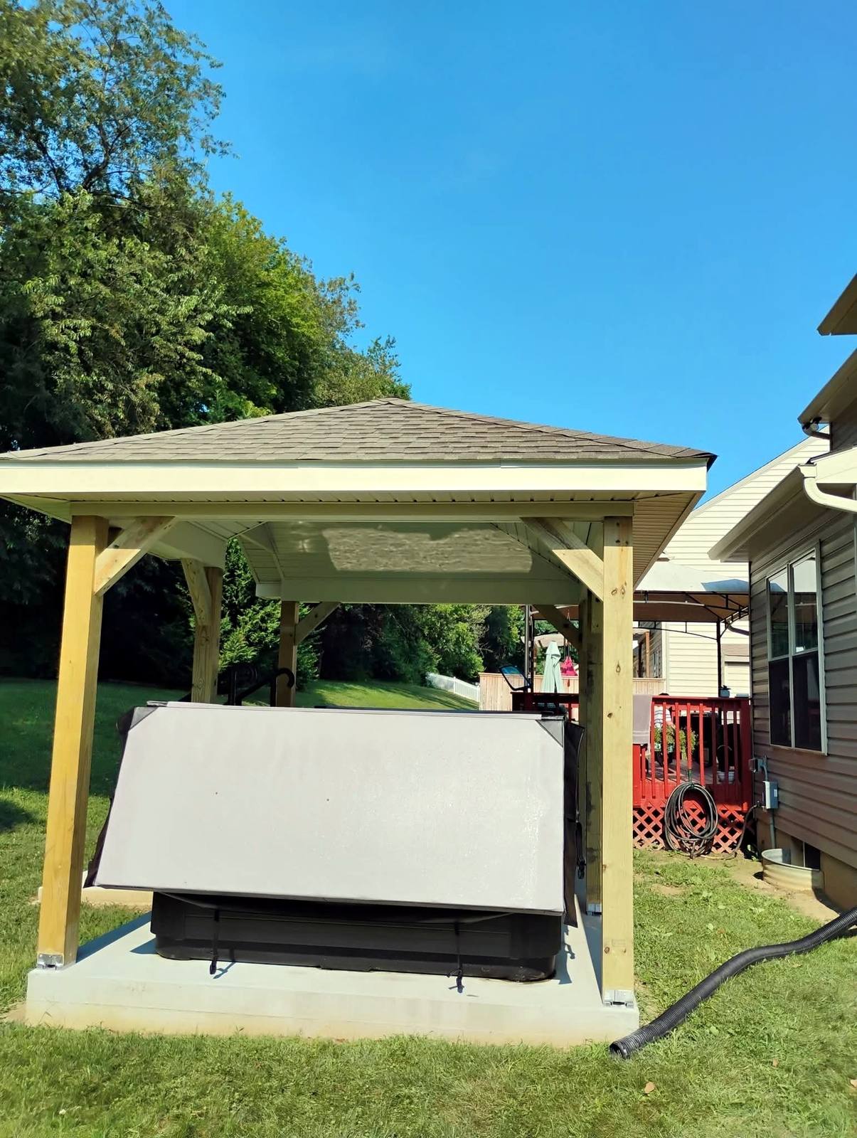 Timber backyard canopy with a finished shingle roof
