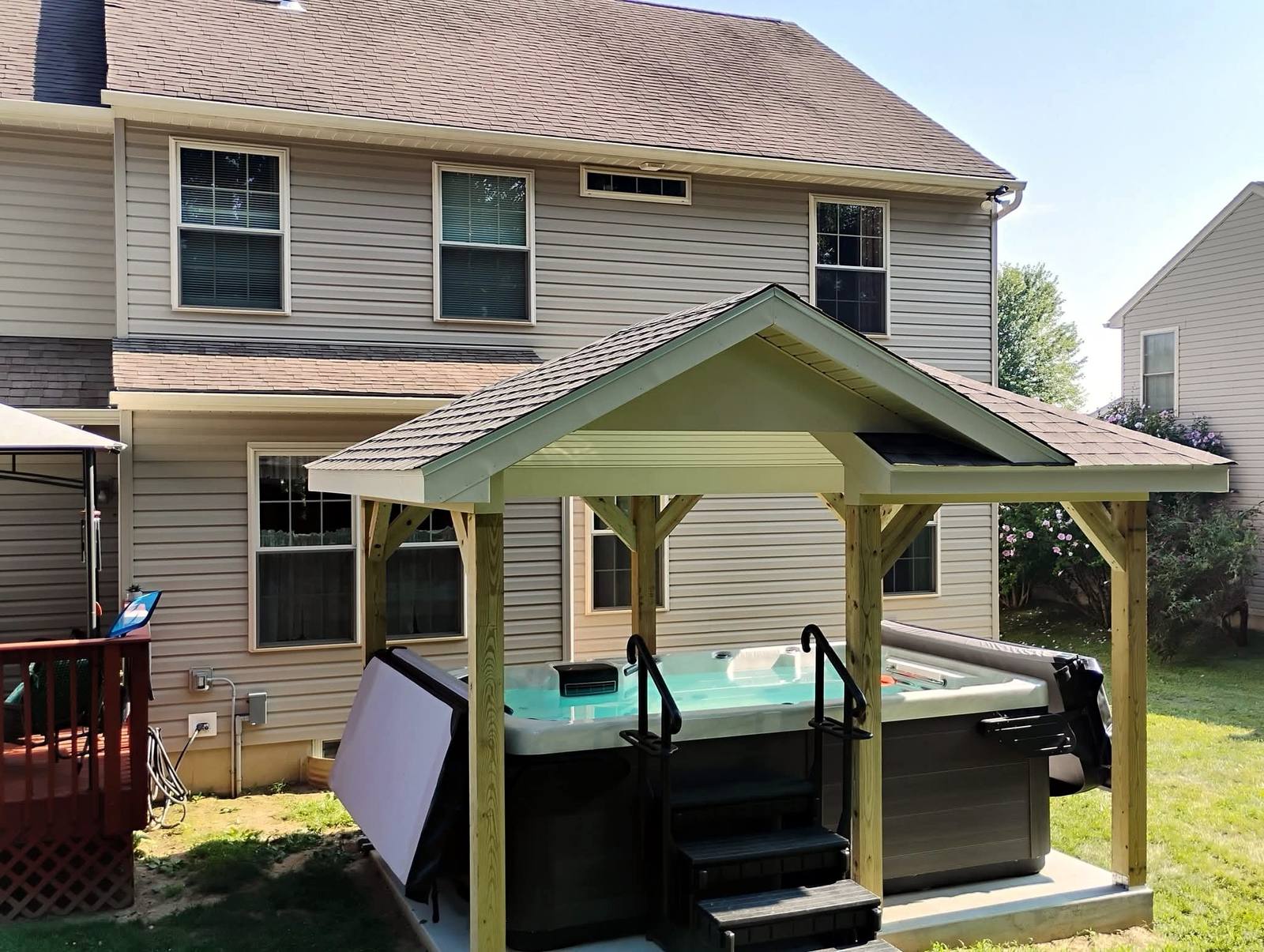 Timber shelter built over a backyard hot tub