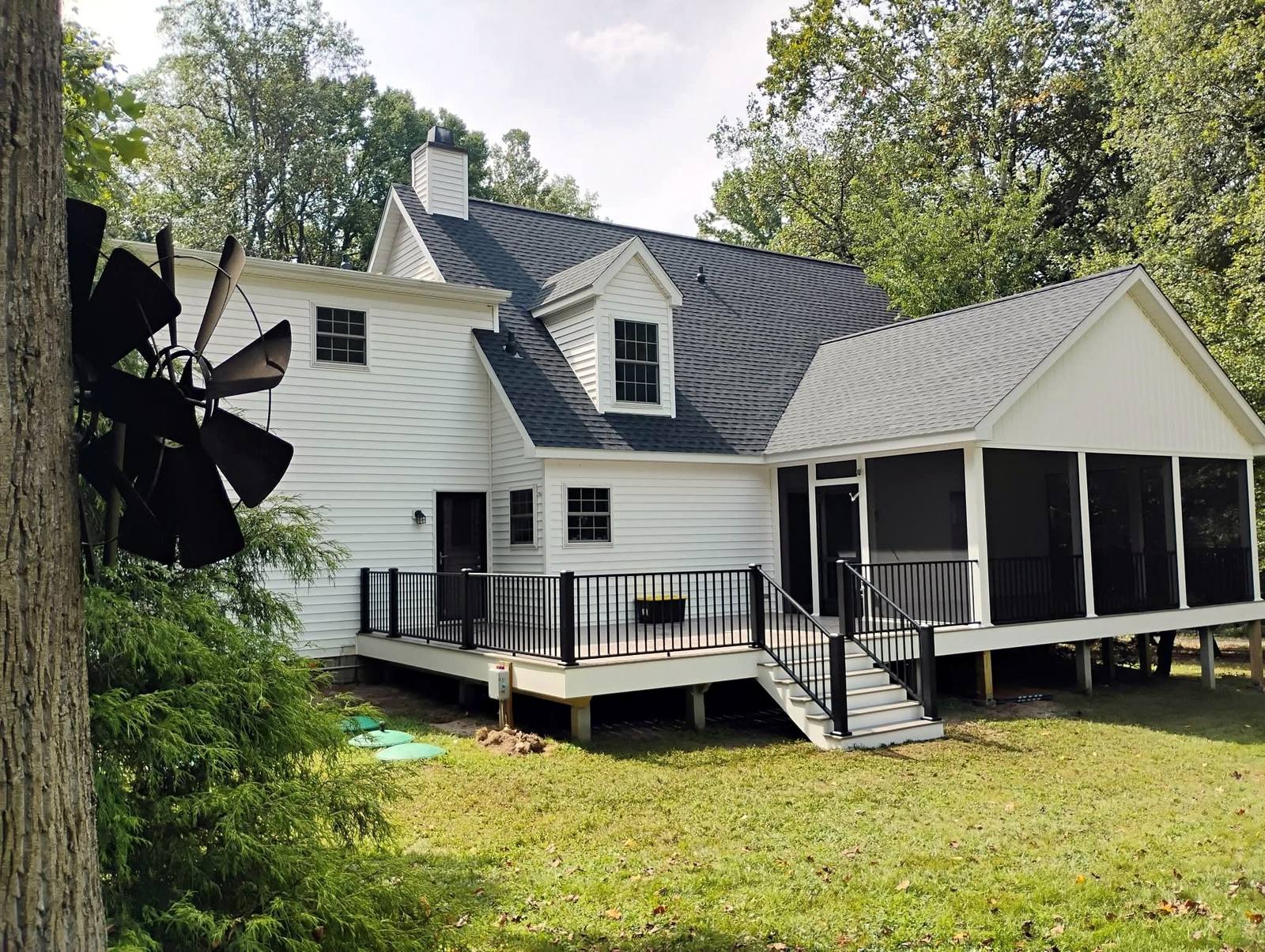 Rear home addition with a screened porch
