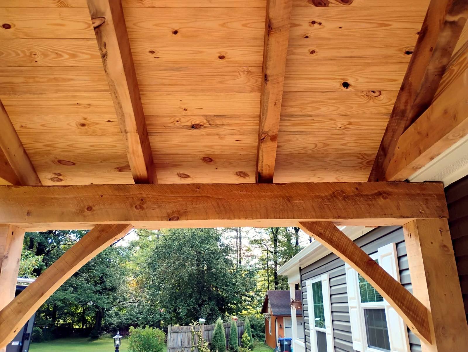 Wood-plank porch ceiling with a ceiling fan