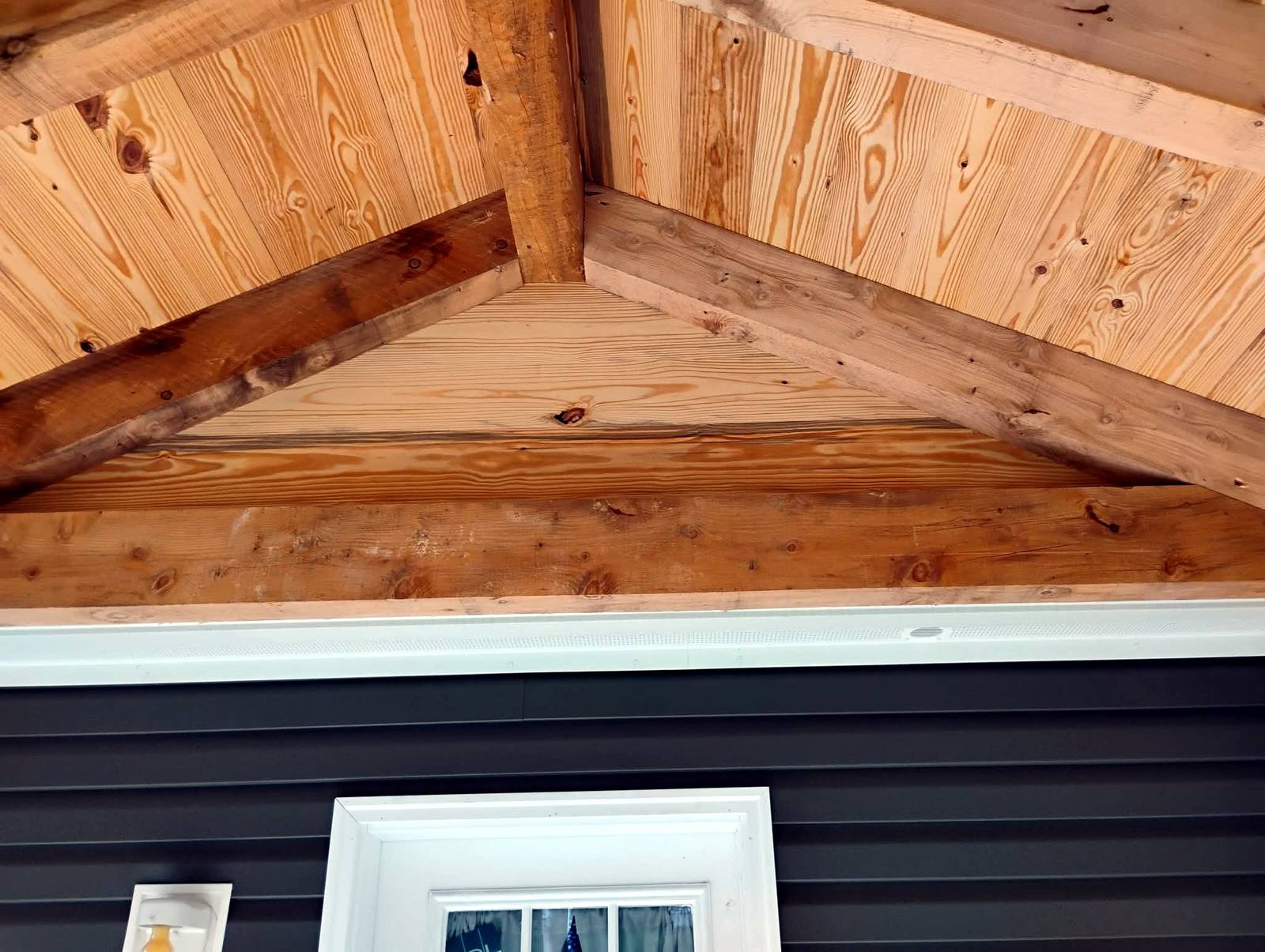 Timber gable framing on a covered porch