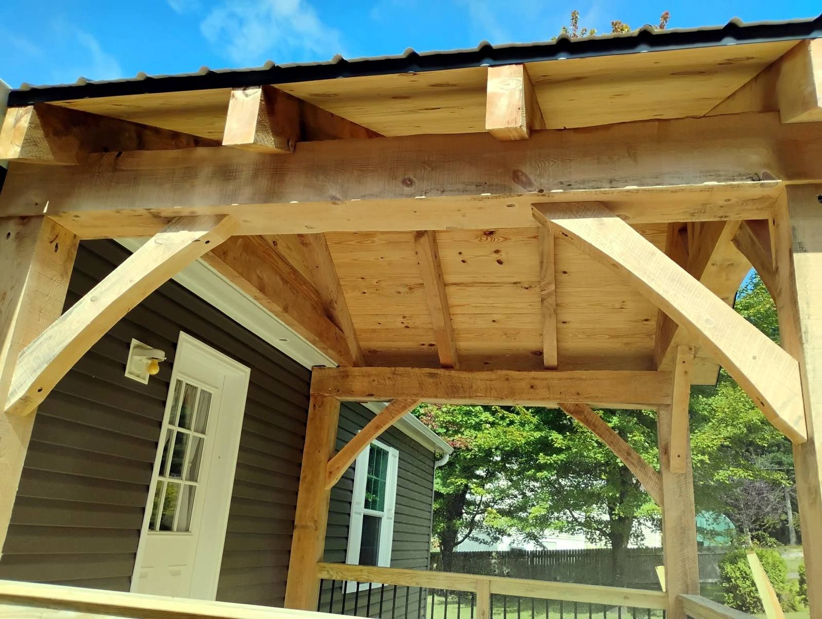 Timber porch posts and roof framing at a home entrance