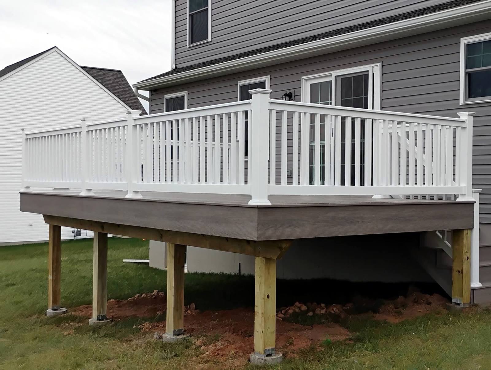 Wide raised deck with white vinyl railings