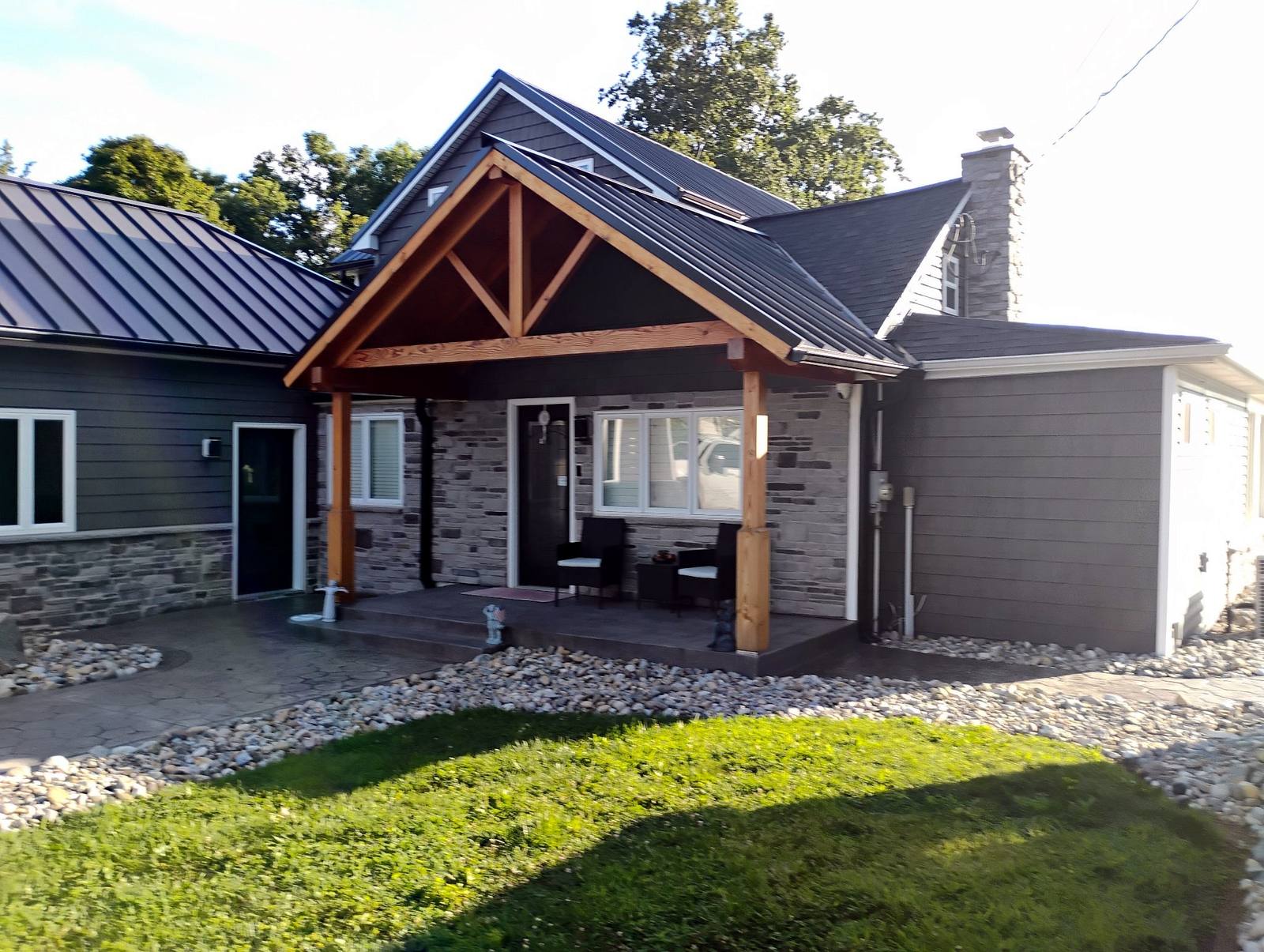 Completed home exterior with stonework and landscaped front yard