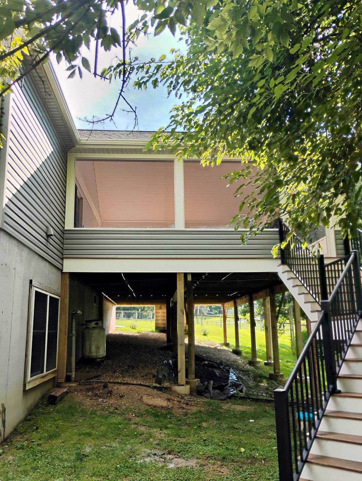 Finished exterior construction beside a landscaped yard