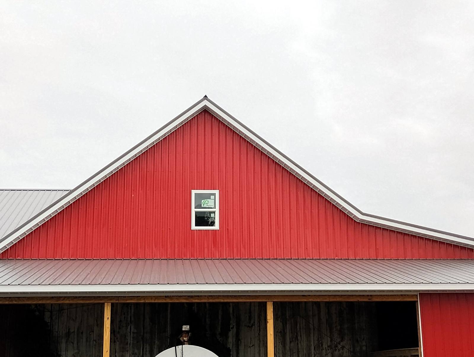 Finished red barn with light-colored roof