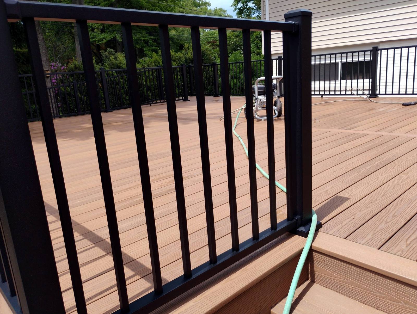 Finished deck stairs and dark railing