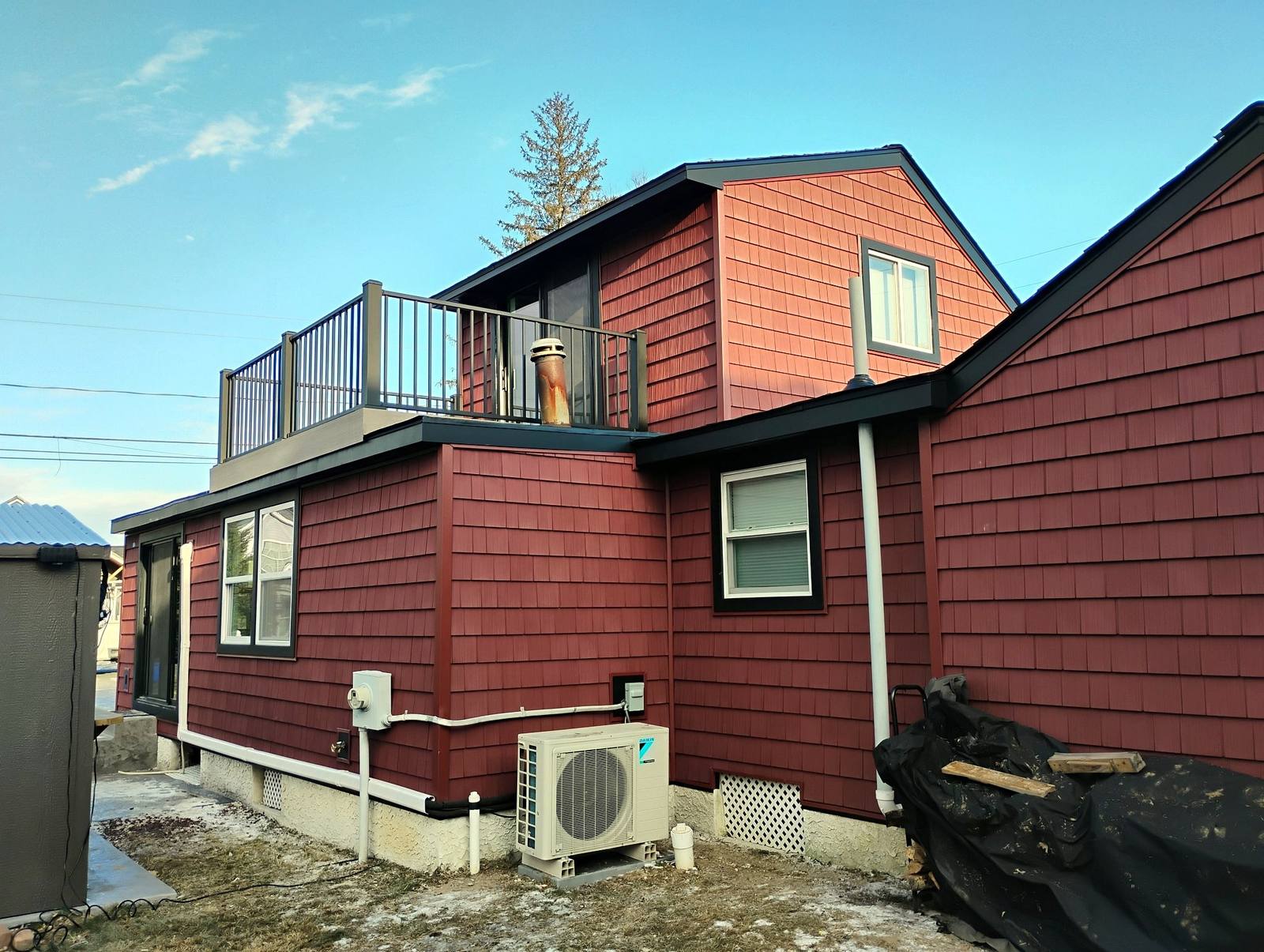 Completed blue metal barn with white trim