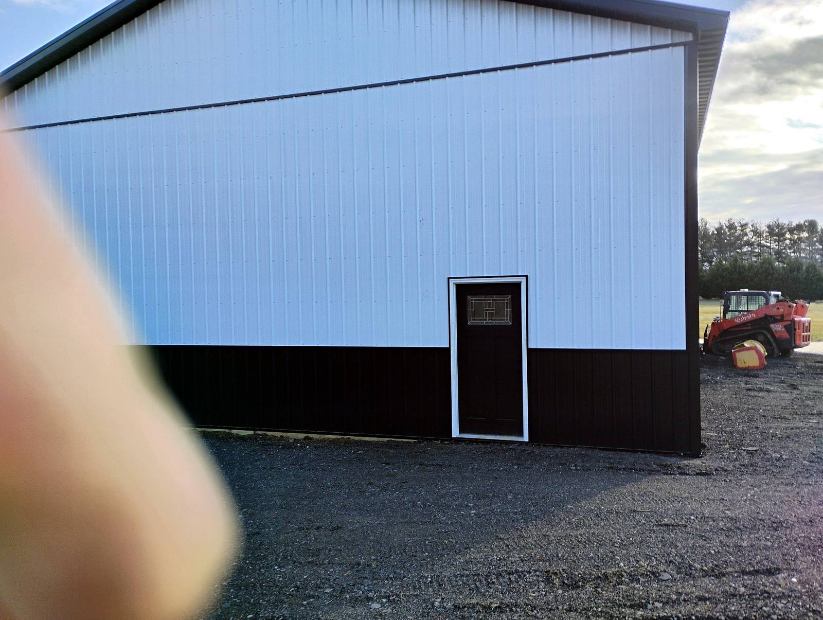 Completed blue metal workshop with white trim