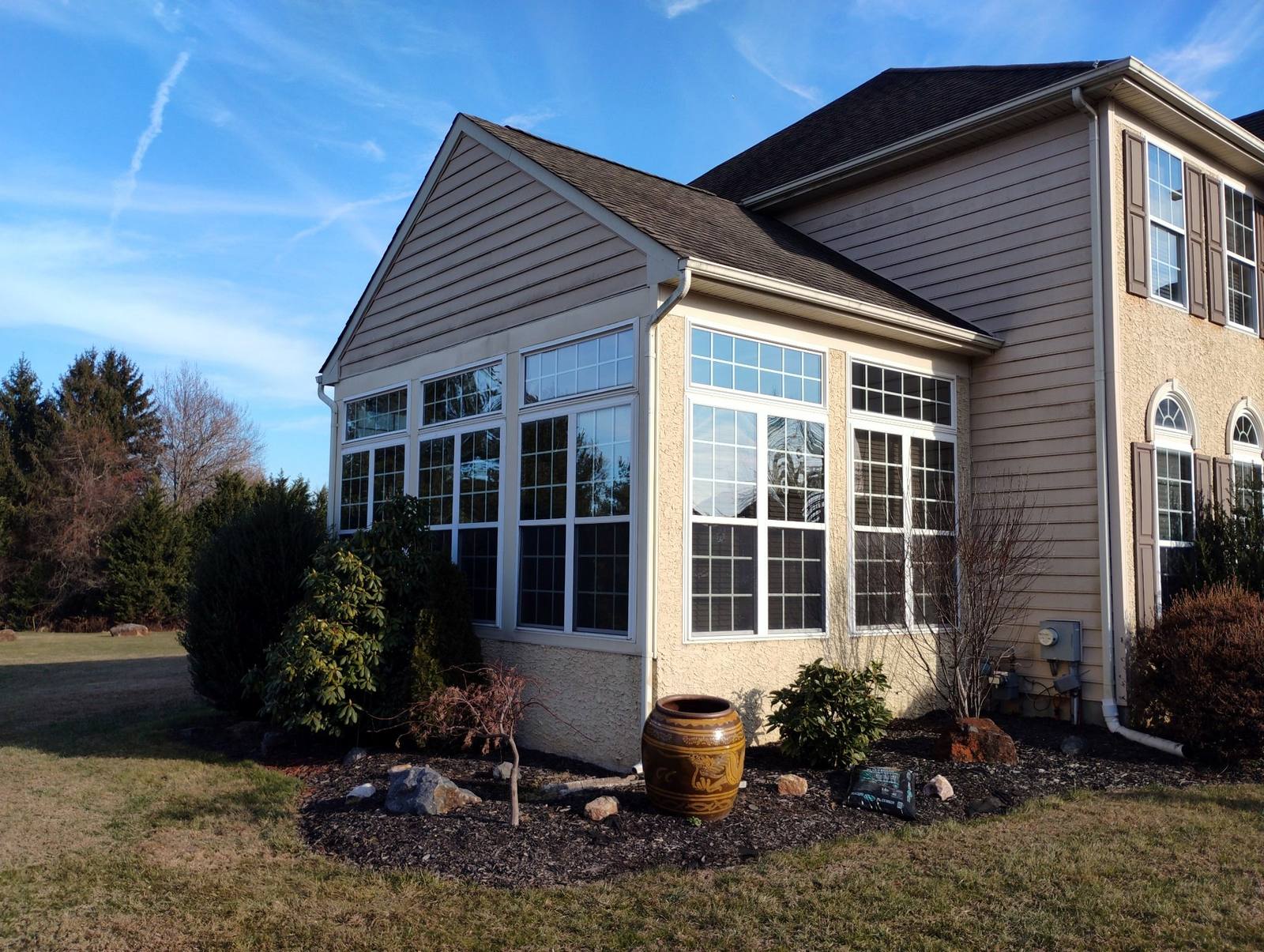 Finished sunroom addition on a brick home