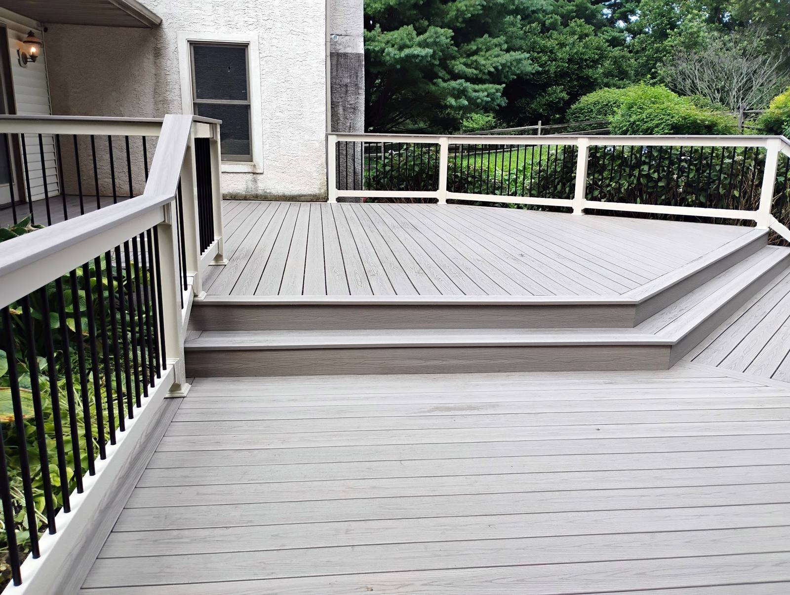 Finished gray deck overlooking a wooded yard