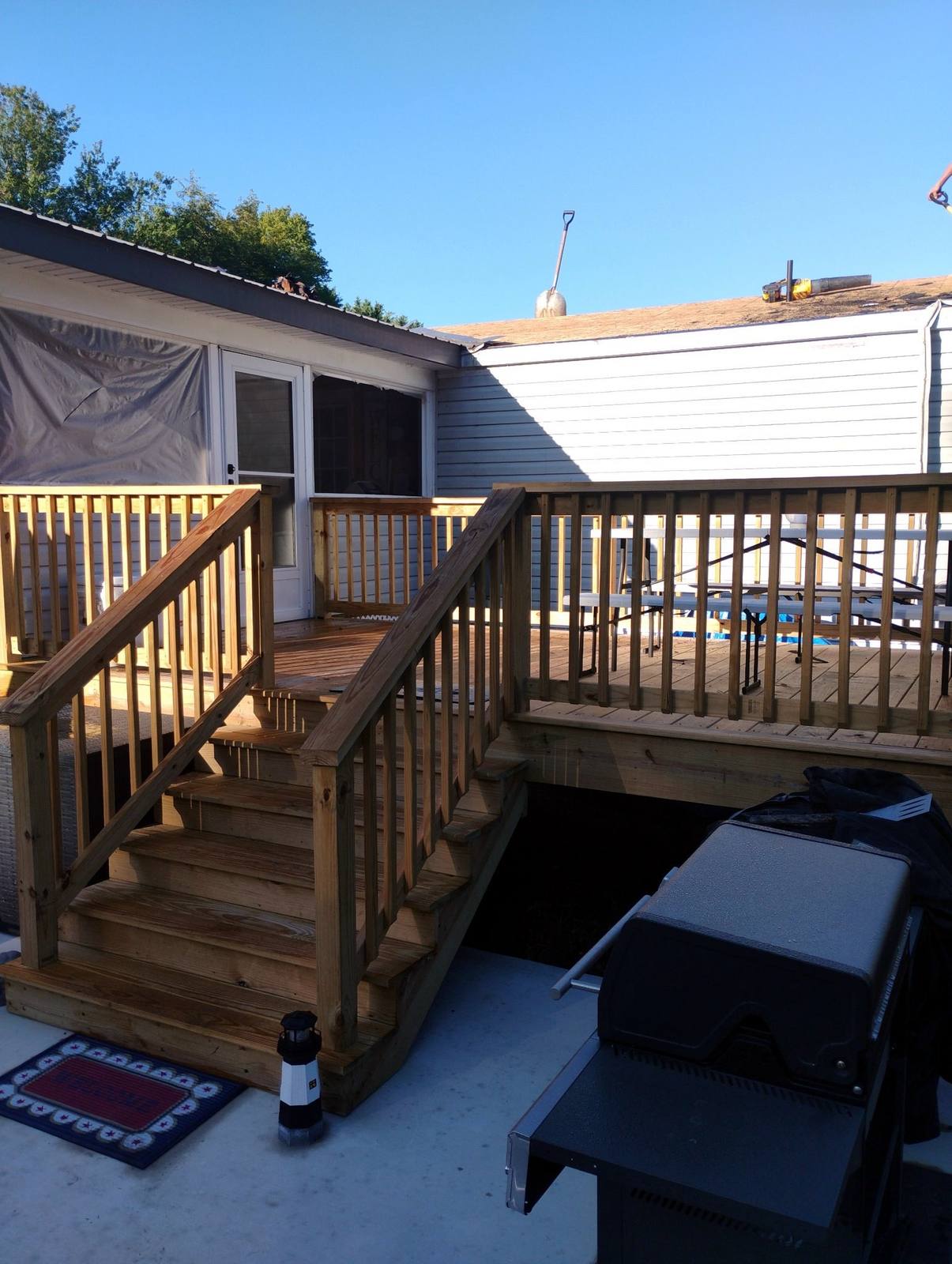 Finished elevated wood deck with stairs and dark railings
