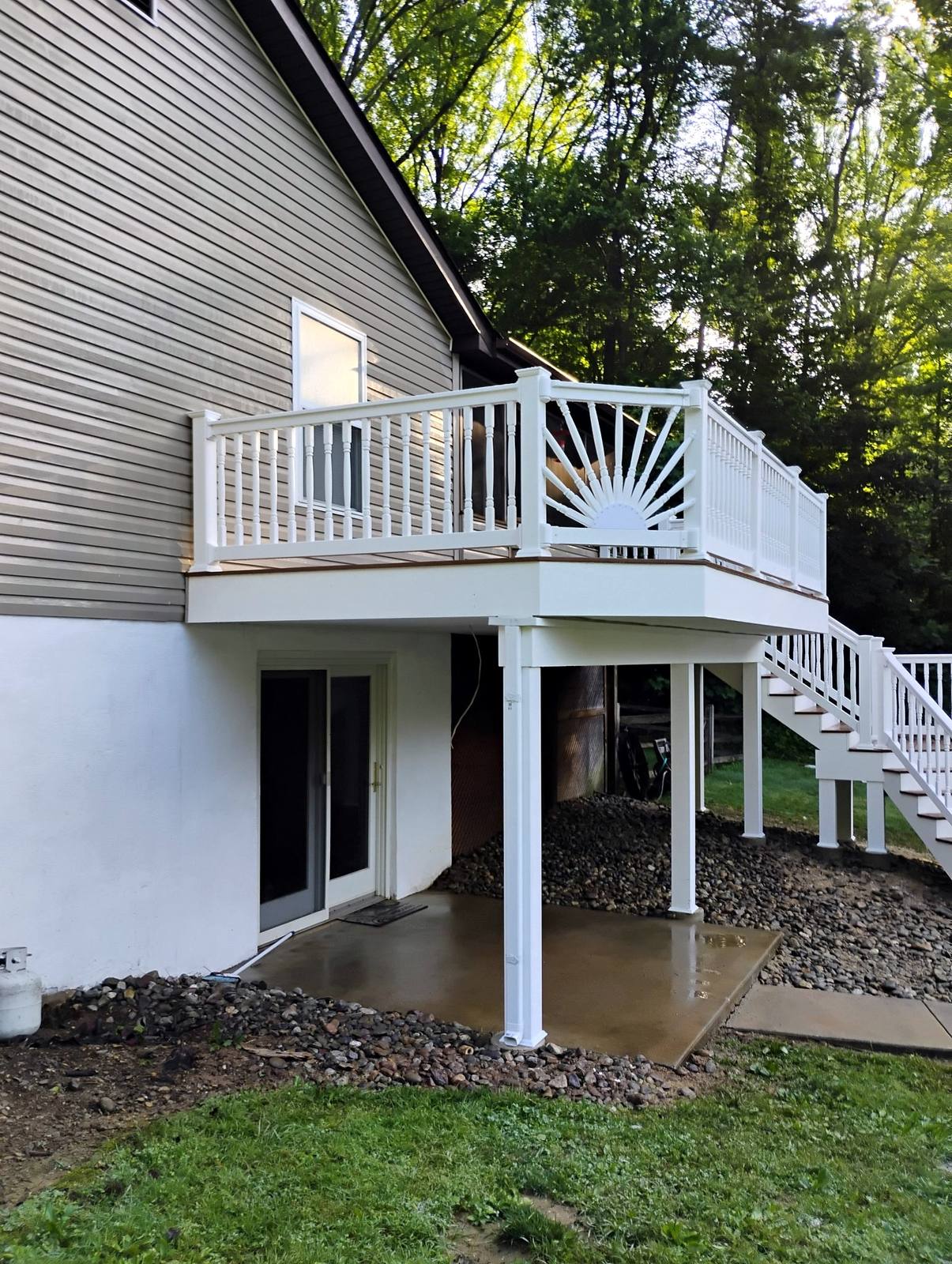 Raised deck with white railings and exterior stairs