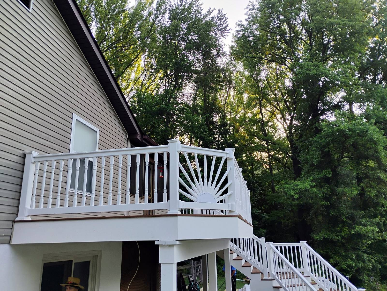 Completed elevated deck with white sunburst railings