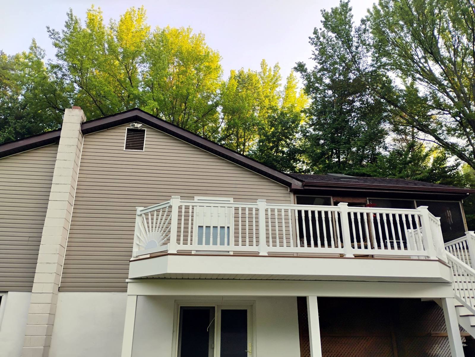 Finished second-story deck on a gray home