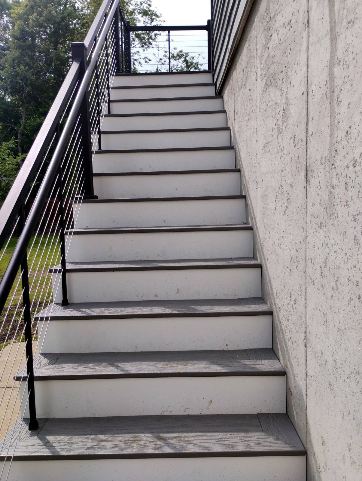 Composite exterior stairs with dark railings