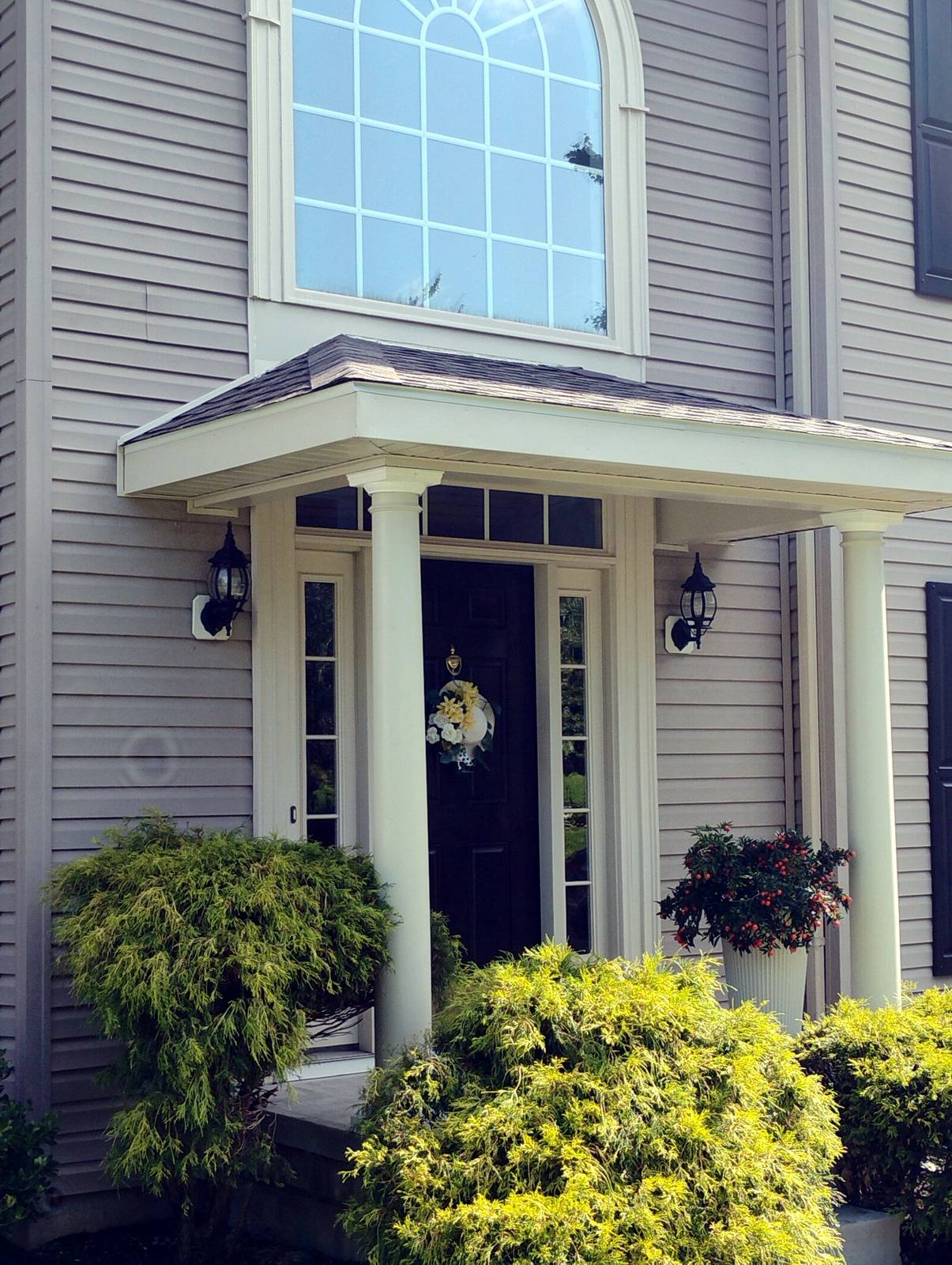 Compact finished front porch with white columns
