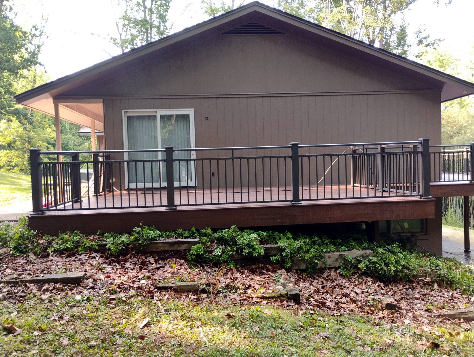 Raised wooden deck across the back of a home