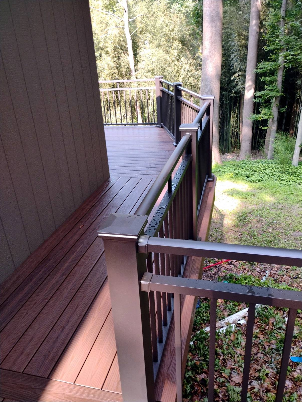 Wood deck corner with finished railing and gate