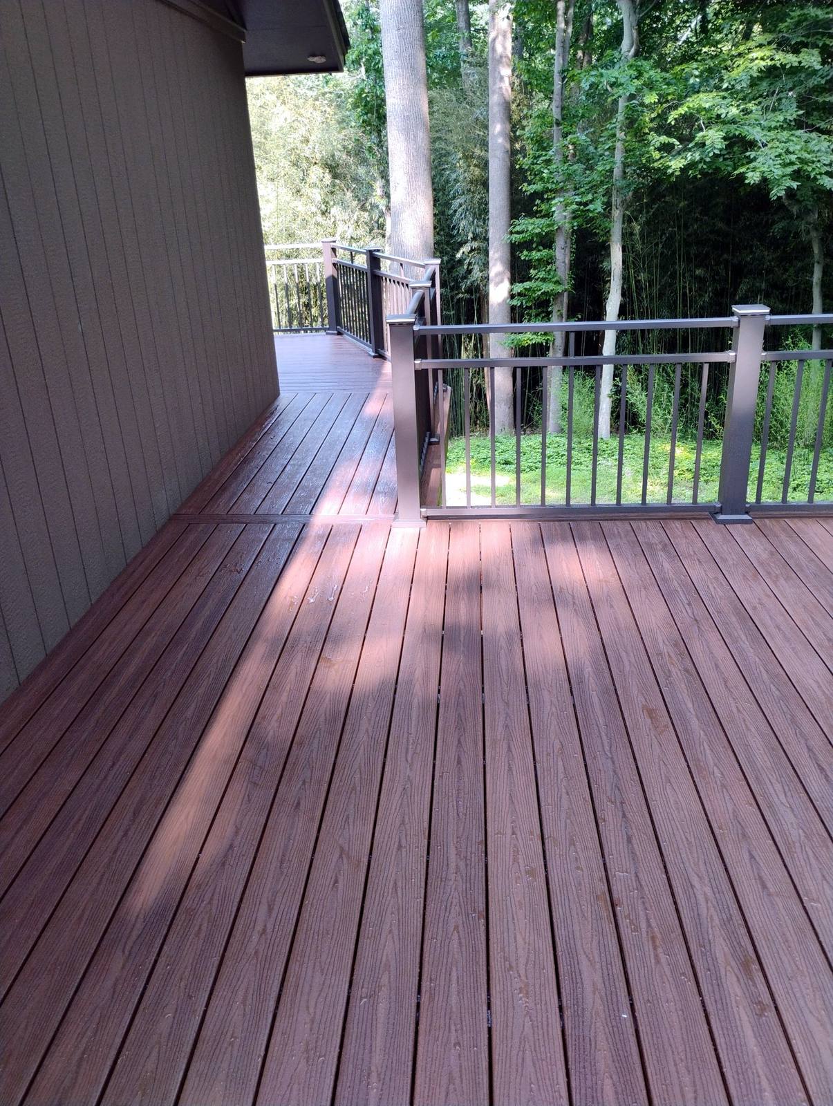 Completed wood deck stairs leading into the yard
