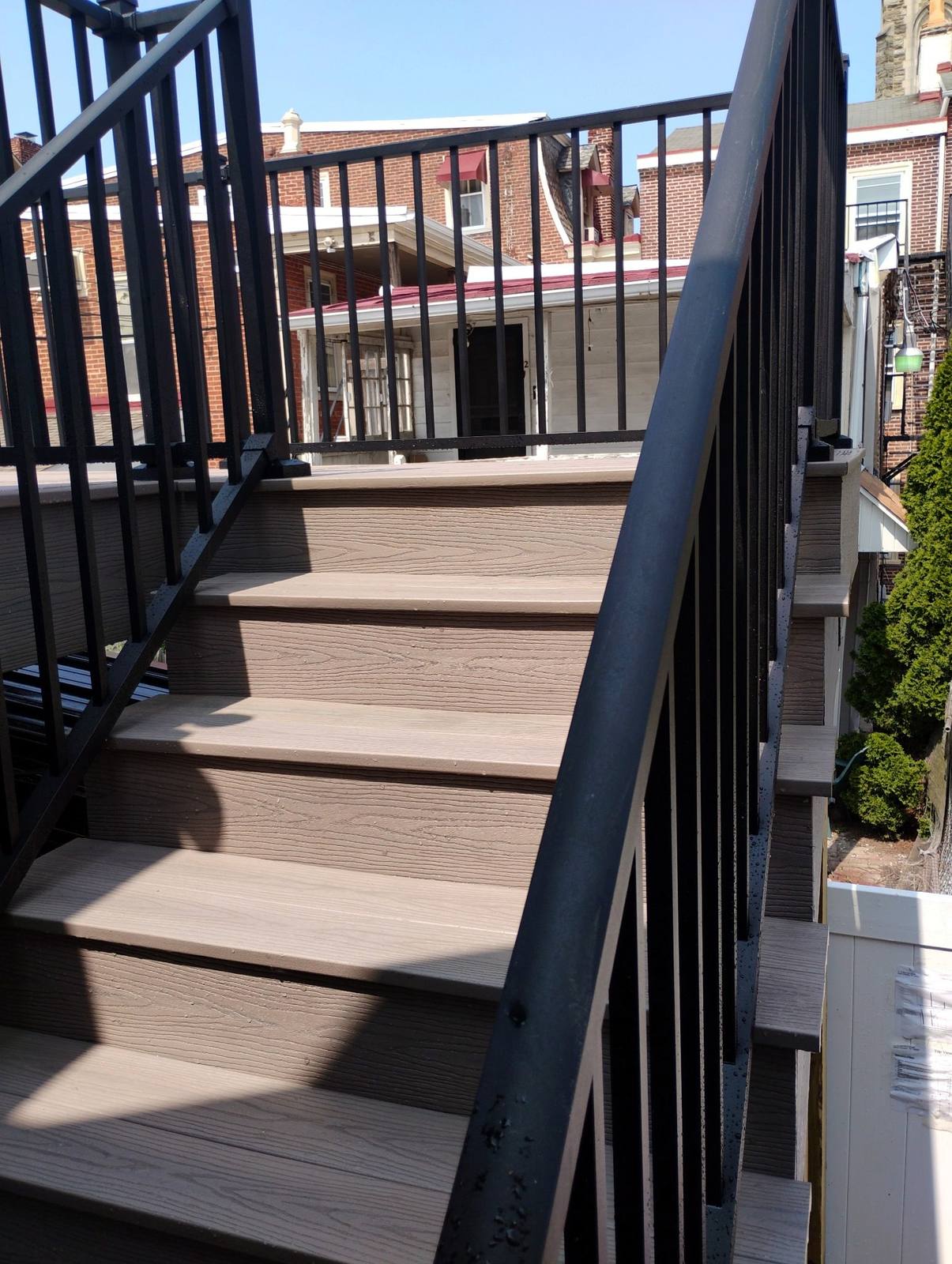 Black metal railing along completed exterior stairs
