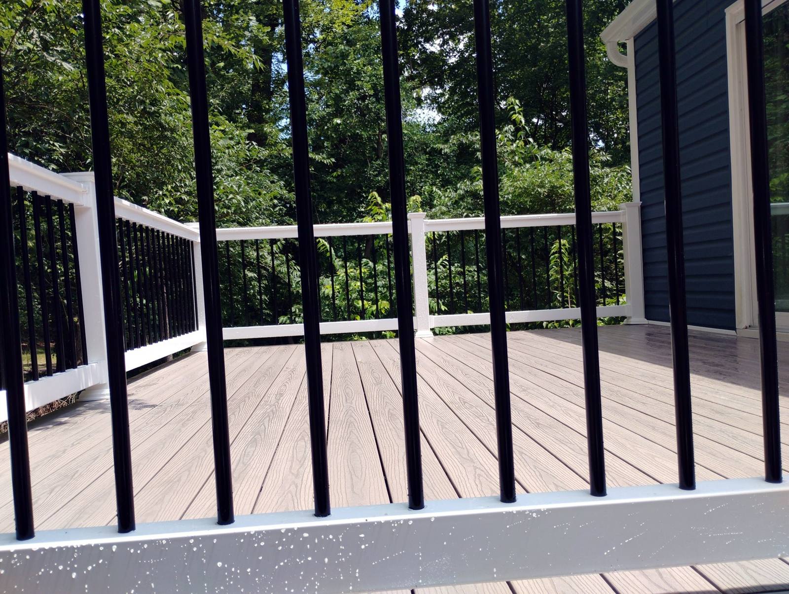 Close view of finished black metal deck railing