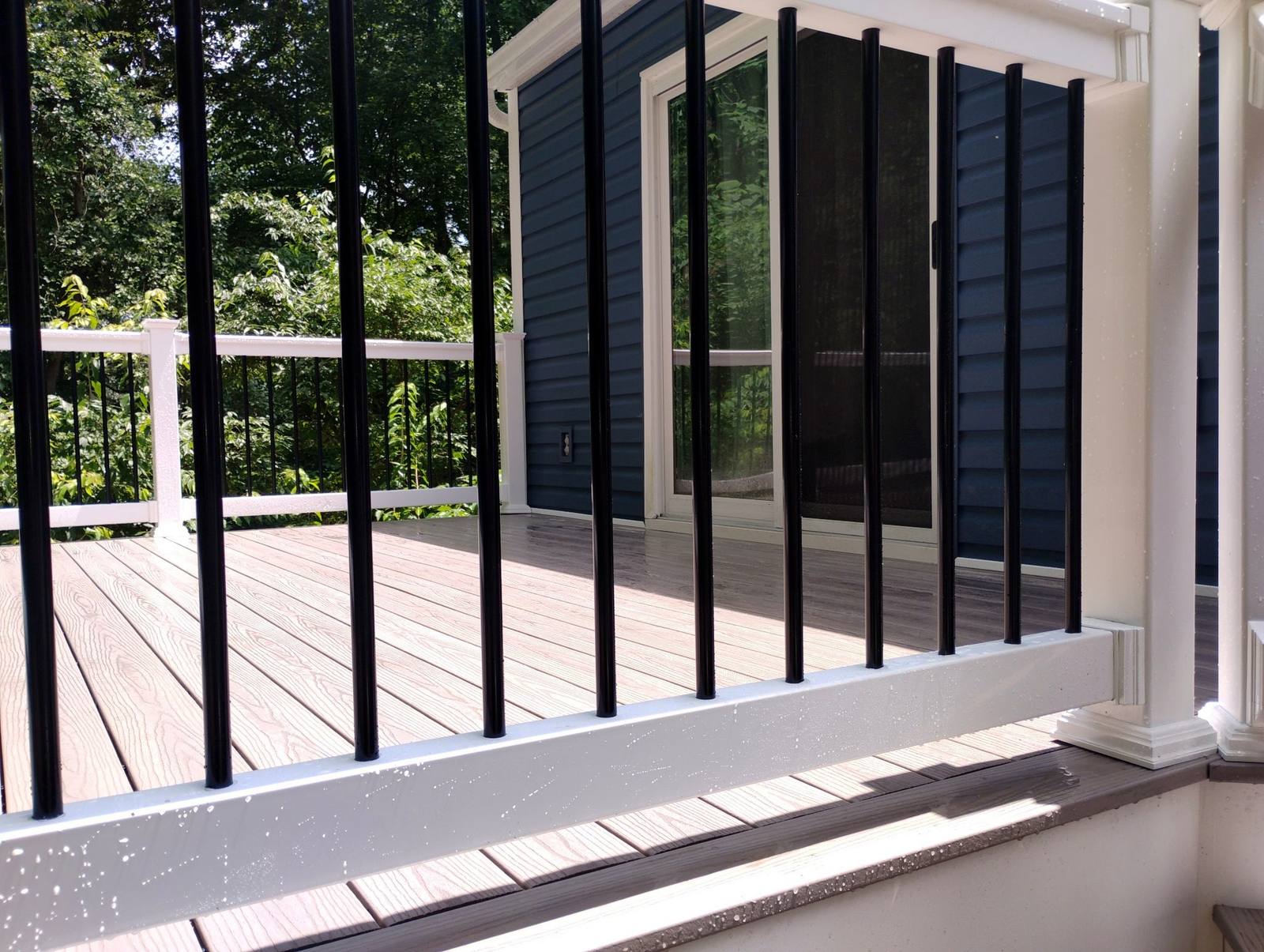 Black metal railing detail on a completed deck