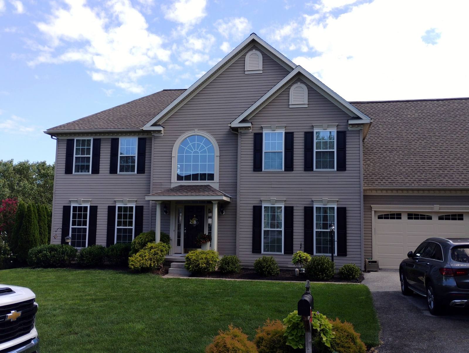 Completed two-story home exterior with covered front entry