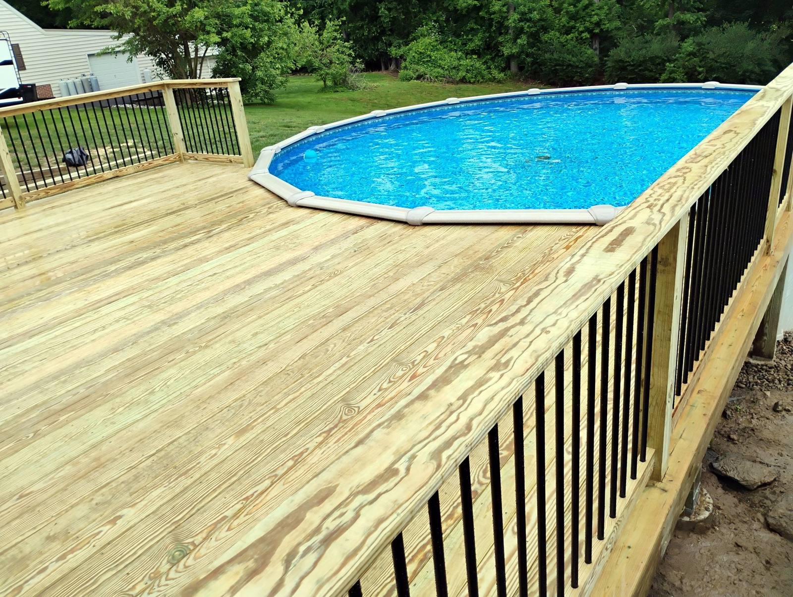 Poolside deck with finished wood railing