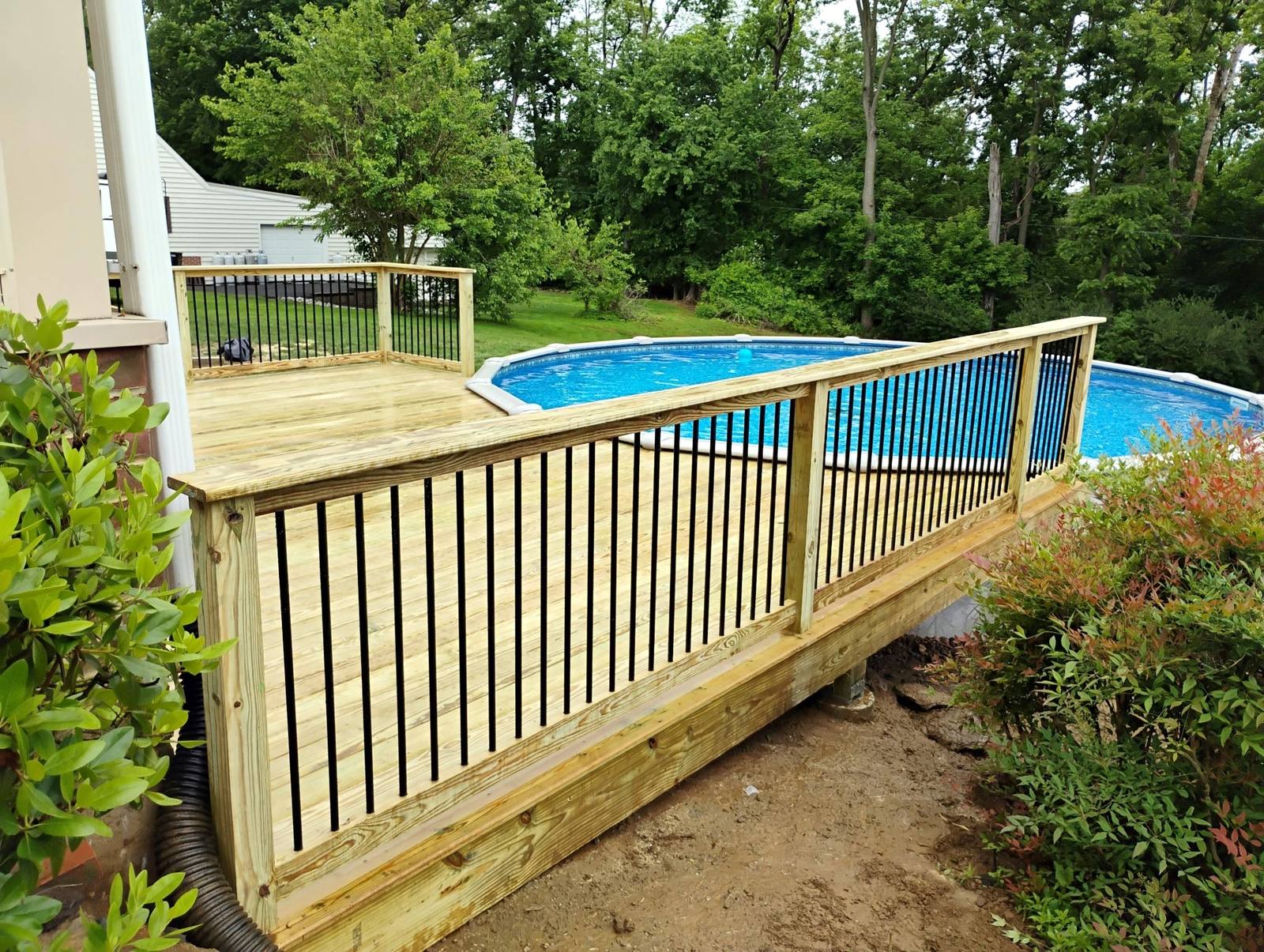 Completed wood steps leading to an above-ground pool deck