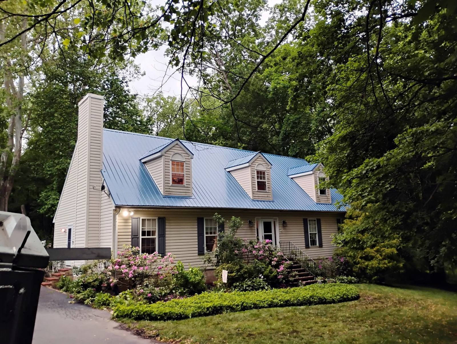Wide view of a finished stone home and front garden