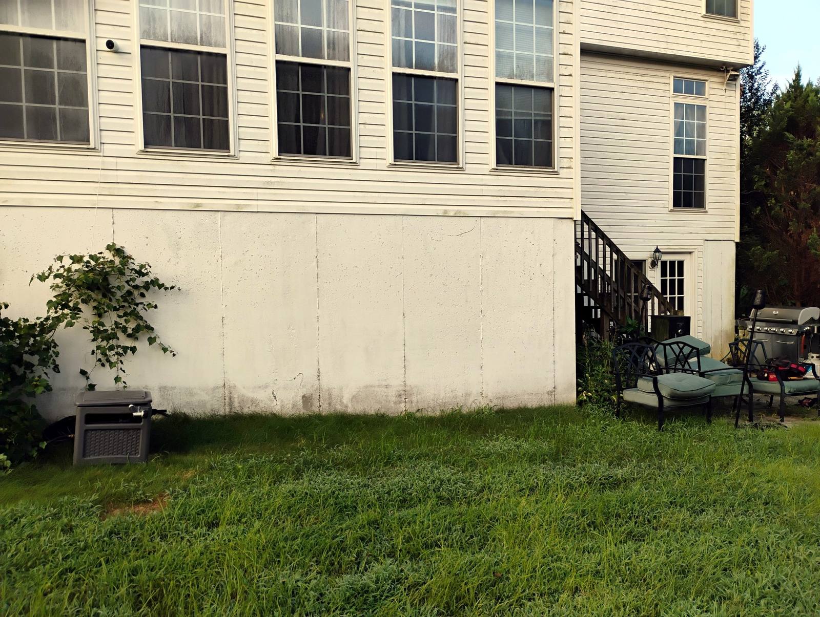 Side yard and finished foundation exterior of a large home