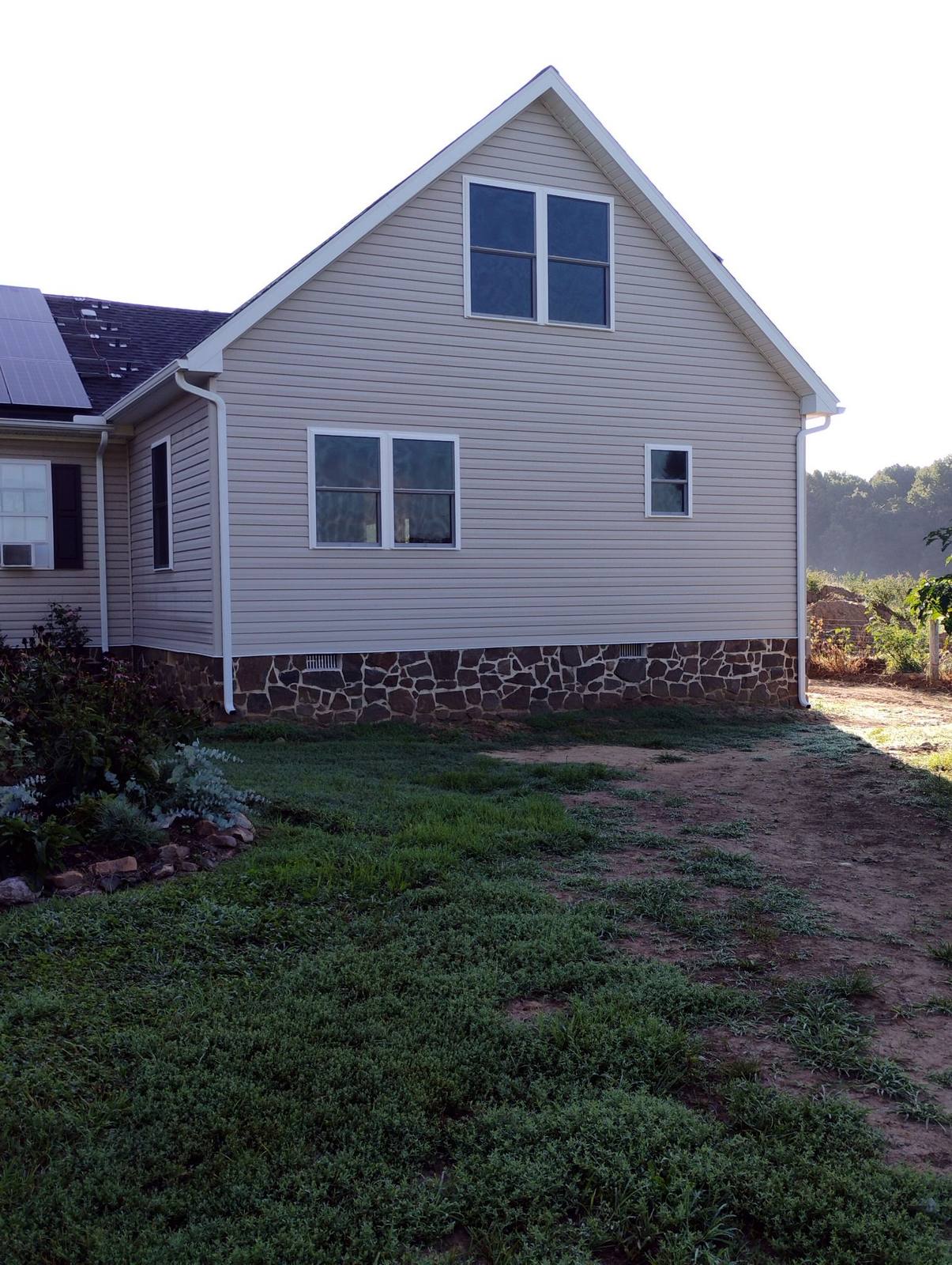 Finished rear home exterior with light siding