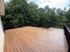 Finished deck landing with black metal railings