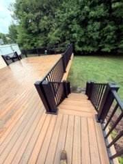 Finished deck steps with black metal railing